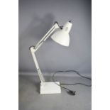 A Luxo white anglepoise lamp.