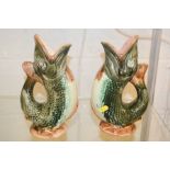 A pair of stoneware glazed fish form Gluggle jugs.