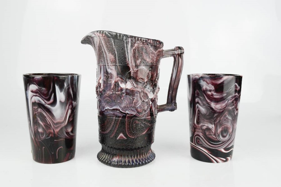 Three examples of slag glass; jug and two beakers.