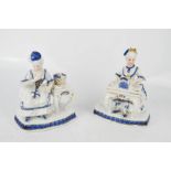 A pair of Delft blue and white figures.