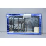 A large Art Deco mirror with blue mirrored border, 91 by 56cm.