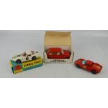 Three toy cars, including Corgi 324, 250 and a Mini Metro.