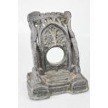 A 19th century lead watch holder, in the form of a castle entrance, 18cm high.