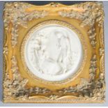 A plaque depicting lovers, in a reproduction gilt frame, 30 by 30cm.