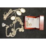 A group of silver jewellery, including three oval lockets, charm bracelet, and six charms, two