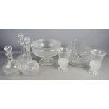 A selection of crystal glass bowls, vases and three decanters.