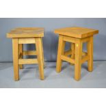 A pair of modern solid oak kitchen stools.