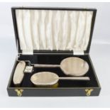 A silver dressing table set, with hand mirror, hair brush, clothes brush, boxed. Birmingham 1969