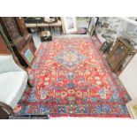 An antique rug, Middle Eastern, 297cm by 200cm.