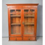 A mahogany glazed wall cabinet.