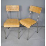 A pair of wooden chairs with metal frame.