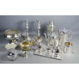 A quantity of silver plateware including a pair of candlesticks, cruet set, cocktail shaker and