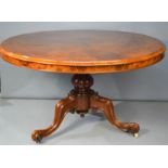 A Victorian walnut centre table, with carved base, circa 1860, top measures 122cm diameter.