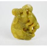 A Chinese jade hand carved double sided dragon and monkey pendant.