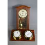 A wall clock, with double clock and barometer.