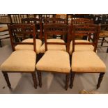 A set of six Edwardian dining chairs with cream upholstered seats.