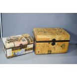 Two decoupaged vintage metal trunks.