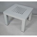 A modern grey metal side table.