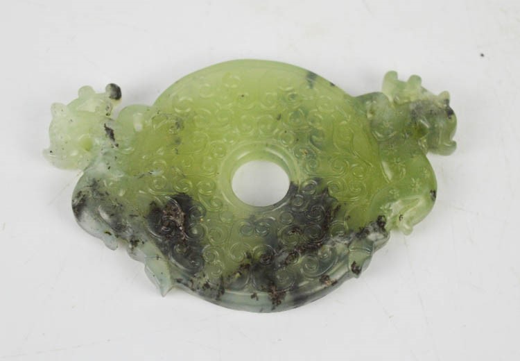 A Chinese Heitian jade carved pendant of two deer.