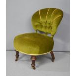 A Victorian green upholstered nursing chair.