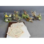 Eight Franklin Mint model birds, together with reference books.