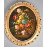 An oval oil on canvas, floral group, 28 by 22cm.