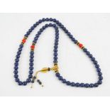 A Tibetan lapis lazuli Buddhist mala prayer beads.