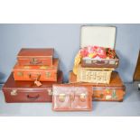 A quantity of vintage suitcases, leather bag, one suitcase and vintage scarves.