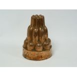 Benham & Froud copper jelly mould of triple tiered circular form, no. 1 with impressed mark, 15cm