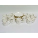 Set of twelve Susie Cooper white & gilt bone china coffee cans & saucers, with gilt initial D, the