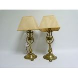 Pair of gimballed brass table lamps, the shield shaped weight on wishbone supports, baluster