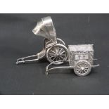 Chinese silver pepperette modelled as a rickshaw & another, a post cart, with embossed