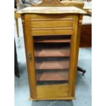 Music cabinet, c.1900, carved pediment above glazed door enclosing shelves, on castors.