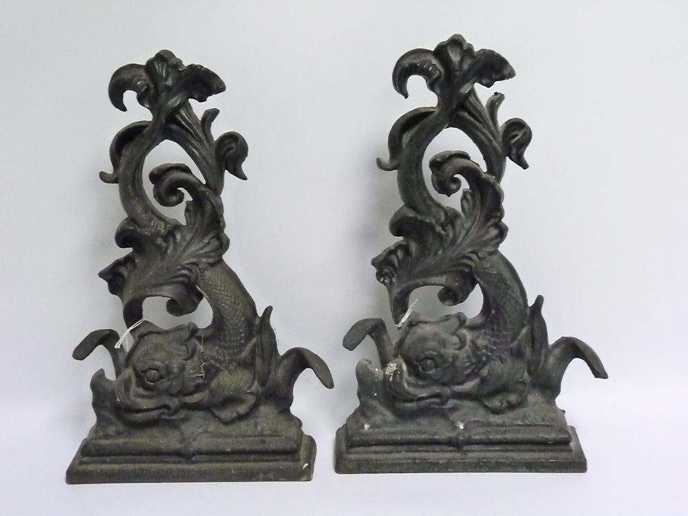 Pair of black painted cast iron doorstops in the form of classical scrolling dolphins, each 41cm