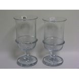 Two large clear glass wine coolers or celery vases, the deep cylindrical bowls each with flared