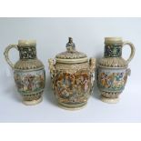 Continental stoneware large covered twin handled jar & a pair of similar ewers with moulded