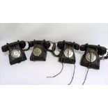 Four vintage early 20th century black Bakelite telephones.