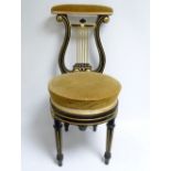 Victorian music chair with upholstered toprail above black & gilt lyre back & circular seat on