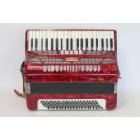 Japanese Tombo piano accordion with red marbled body, serial no. VJA 014, with case.