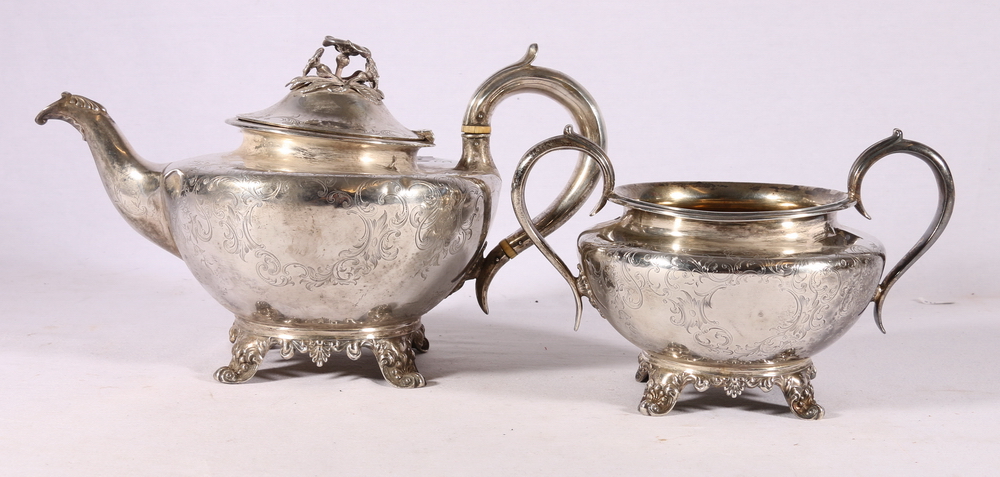 Victorian silver teapot and twin-handled sugar basket decorated with engraved foliate sprays and