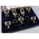 Edward VII Art Nouveau silver seven piece cruet set with pierced bodies and green glass liners by