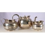 Victorian silver three piece tea set of globular form with half-reeded body, leaf band to the