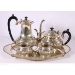 Eastern white metal four piece tea service on tray, each piece with gadrooned decoration and bead