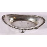 George V silver stand of boat shape with gadrooned border raised on ball and claw supports by