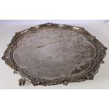 Victorian silver salver with scalloped edge and engraved surface raised on ball and claw supports by