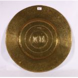 Arts and Crafts brass charger with initials NM or WN to the centre, 59cm diameter