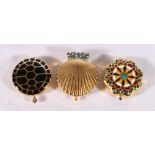 Three Estee Lauder powder compacts, one of scallop shell form 6cm wide, (3)