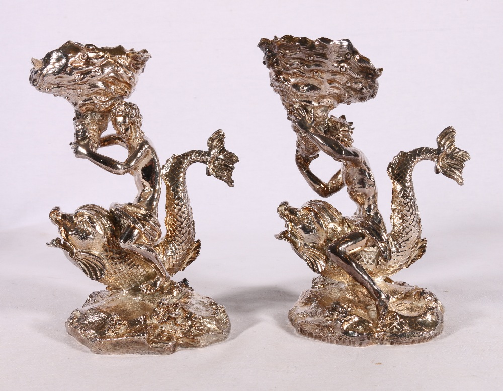 Pair of cast white metal figures models as a king (possibly Neptune) and Queen riding dolphins