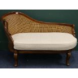 Reproduction bergere chaise longue, raised on cabriole supports, 131 cm wide.