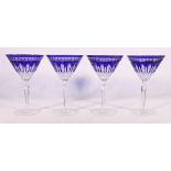 A set of four Waterford blue bohemian glasses, 18cm tall.